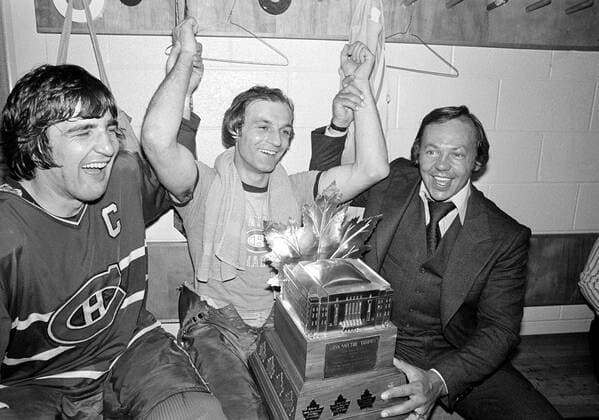 May 14, 1977, BOSTON, Canada: Montreal Canadiens Guy Lafleur, center, team captain Serge Savard, left, and Yvan Cournoyer celebrate Lafleur s win of the Conn Smythe Most Valuable Player trophy in the team s dressing room after their Stanley Cup victory at Boston Garden in Boston, Ma., May 14, 1977. Cournoyer was on the injured players list.Montreal Canadiens legend Guy Lafleur has died at age 70. Canada News - May 14, 1977  - ZUMAc35_ 19770514_zaf_c35_001 Copyright: xThexCanadianxPressx