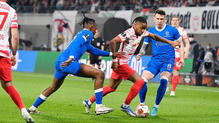 Soccer UEFA Europa League, semi-final, first leg season 2021 2022, RB Leipzig vs Glasgow Rangers 28 04 2022 Duel for the ball between Joe Aribo Central midfield Glasgow Rangers, back number 17 , Christopher Nkunku Offensive midfield RB Leipzig, back number 18, 18 , Ryan Jack Central midfield Glasgow Rangers, back number 8 v l n r during the match RB Leipzig vs Glasgow Rangers 28 04 2022 Leipzig Saxony Germany Red Bull Arena