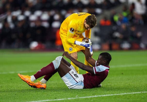 Mandatory Credit: Photo by Simon Dael Shutterstock (12914205dg) Kurt Zouma of West Ham United gets another knock and is helped to his feet by Goalkeeper Kevin Trapp of Eintracht Frankfurt West Ham United v Eintracht Frankfurt, UEFA Europa League, Semi-Final, First Leg, Football, The London Stadium, London, UK - 28 Apr 2022 EDITORIAL USE ONLY No use with unauthorised audio, video, data, fixture lists, club league logos or live services. Online in-match use limited to 120 images, no video emulation. No use in betting, games or single club league player publications. West Ham United v Eintracht Frankfurt, UEFA Europa League, Semi-Final, First Leg, Football, The London Stadium, London, UK - 28 Apr 2022 EDITORIAL USE ONLY No use with unauthorised audio, video, data, fixture lists, club league logos or live services. Online in-match use limited to 120 images, no video emulation. No use in betting, games or single club league player publications.  Copyright: xSimonxDael Shutterstockx 12914205dg