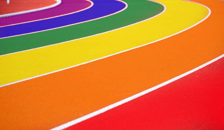 Symbol image queer in sports running track of athletics facility in rainbow colors composing Copyright: xx