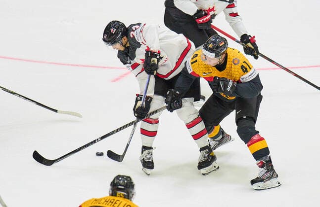 Jonas Mueller, Müller 41 of Germany compete, fight for the puck against, Dylan Cozens Nr. 24 of Canada in the match GERMANY - CANADA IIHF Ice hockey, Eishockey World Championship, WM, Weltmeisterschaft Group B in Helsinki, Finland, May 13, 2022, Season 2021 2022