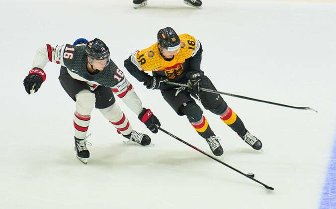 Tim Stützle Nr.18 of Germany compete, fight for the puck against, Morgan Geekie Nr. 16 of Canada in the match GERMANY - CANADA IIHF Ice hockey, Eishockey World Championship, WM, Weltmeisterschaft Group B in Helsinki, Finland, May 13, 2022, Season 2021 2022