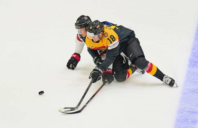 Tim Stützle Nr.18 of Germany compete, fight for the puck against, Morgan Geekie Nr. 16 of Canada in the match GERMANY - CANADA IIHF Ice hockey, Eishockey World Championship, WM, Weltmeisterschaft Group B in Helsinki, Finland, May 13, 2022, Season 2021 2022