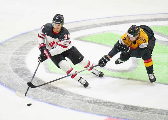 Maximilian Kastner Nr.7 of Germany compete, fight for the puck against, Cole Sillinger Nr. 34 of Canada in the match GERMANY - CANADA IIHF Ice hockey, Eishockey World Championship, WM, Weltmeisterschaft Group B in Helsinki, Finland, May 13, 2022, Season 2021 2022