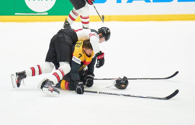 Maximilian Kastner Nr.7 of Germany compete, fight for the puck against, Morgan Geekie Nr. 16 of Canada in the match GERMANY - CANADA IIHF Ice hockey, Eishockey World Championship, WM, Weltmeisterschaft Group B in Helsinki, Finland, May 13, 2022, Season 2021 2022