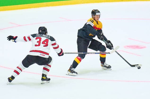 Tim Stützle Nr.18 of Germany compete, fight for the puck against, Cole Sillinger Nr. 34 of Canada in the match GERMANY - CANADA 3-5 IIHF Ice hockey, Eishockey World Championship, WM, Weltmeisterschaft Group B in Helsinki, Finland, May 13, 2022, Season 2021 2022
