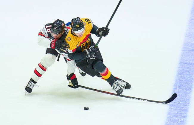 Tim Stützle Nr.18 of Germany compete, fight for the puck against, Morgan Geekie Nr. 16 of Canada in the match GERMANY - CANADA 3-5 IIHF Ice hockey, Eishockey World Championship, WM, Weltmeisterschaft Group B in Helsinki, Finland, May 13, 2022, Season 2021 2022