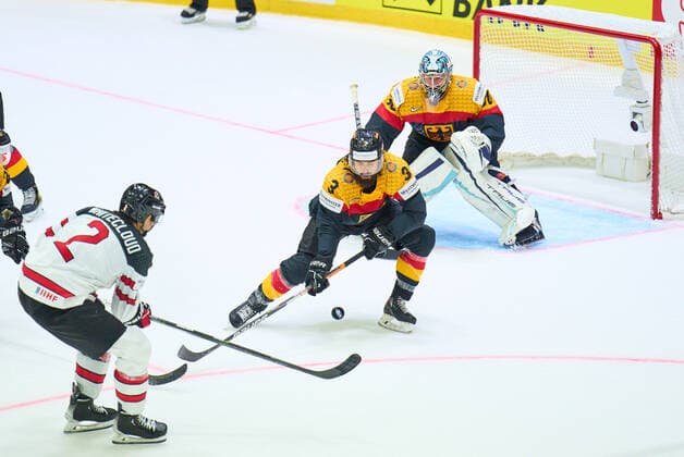 Zach Whitecloud Nr. 2 of Canada compete, fight for the puck against, Dominik BITTNER Nr.3 of Germany Philipp GRUBAUER Goalie Nr.30 of Germany in the match GERMANY - CANADA 3-5 IIHF Ice hockey, Eishockey World Championship, WM, Weltmeisterschaft Group B in Helsinki, Finland, May 13, 2022, Season 2021 2022