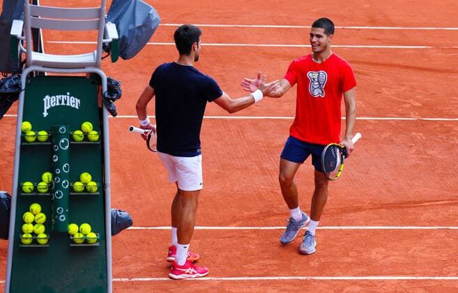 Mandatory Credit: Photo by Javier Garcia Shutterstock (12942467as) Novak Djokovic and Carlos Alcaraz shake hands after a hard fought practice match on Philippe Chatrier Court French Open Tennis, Friday Previews, Roland Garros, Paris, France - 20 May 2022 French Open Tennis, Friday Previews, Roland Garros, Paris, France - 20 May 2022  Copyright: xJavierxGarcia Shutterstockx 12942467as