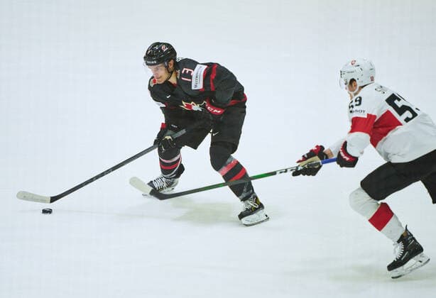 Matt Barzal Nr. 13 of Canada compete, fight for the puck against, Dario Simion Nr. 59 of Switzerland in the match CANADA - SWITZERLAND of the IIHF Ice hockey, Eishockey World Championship, WM, Weltmeisterschaft Group B in Helsinki, Finland, May 21, 2022, Season 2021 2022
