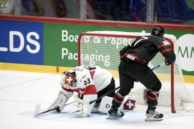 Adam Lowry of Canada scores 2-1 goal against goalkeeper Leonardo Genoni of Switzerland during the 2022 IIHF Ice hockey, Eishockey World Championships preliminary round group A match between Canada and Switzerland in Helsinki on May 21, 2022. Helsinki Finland LKFTVX20220521172035EJKB  Copyright: xMikkoxStigx