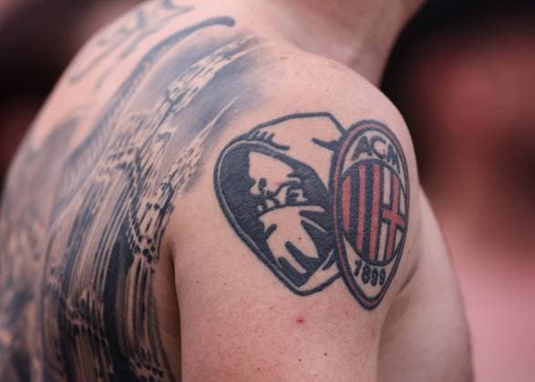 Sassuolo, Italy, 22nd May 2022. Tattoos are seen on the back and shoulder of an AC Milan fan during the Serie A match at Mapei Stadium - Citt? del Tricolore, Sassuolo. Picture credit should read: Jonathan Moscrop Sportimage EDITORIAL USE ONLY. No use with unauthorised audio, video, data, fixture lists, club league logos or live services. Online in-match use limited to 120 images, no video emulation. No use in betting, games or single club league player publications. SPI-1708-0187