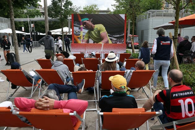 Visitors to Roland Garros watch a match from a TV screen during the French Tennis Open, near Paris, France, on Sunday May 29, 2022.  PAR20220529124 MAYAxVIDON-WHITE
