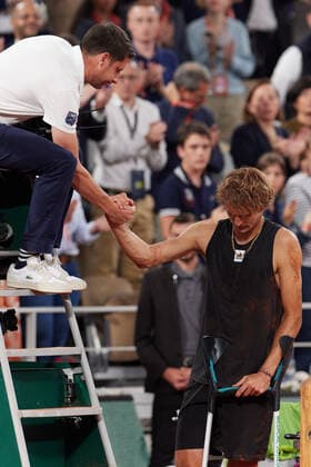 (220604) -- PARIS, June 4, 2022 -- Alexander Zverev with crutches gestures to referee as he retires from the match after sustaining an injury during the men s singles semifinal match between Alexander Zverev of Germany and Rafael Nadal of Spain at the French Open tennis tournament at Roland Garros in Paris, France, June 3, 2022. ) (SP)FRANCE-PARIS-TENNIS-ROLAND GARROS-FRENCH OPEN-MEN S SINGLES SEMIFINAL MengxDingbo 