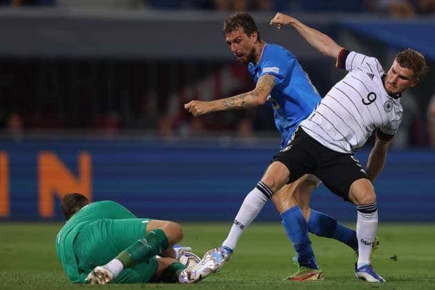 Bologna, Italy, 4th June 2022. Gianluigi Donnarumma of Italy saves the ball at the free of Timo Werner of Germany as Francesco Acerbi of Italy provides support during the UEFA Nations League match at Stadio Renato Dall Ara, Bologna. Picture credit should read: Jonathan Moscrop Sportimage EDITORIAL USE ONLY. No use with unauthorised audio, video, data, fixture lists, club league logos or live services. Online in-match use limited to 120 images, no video emulation. No use in betting, games or single club league player publications. SPI-1724-0015