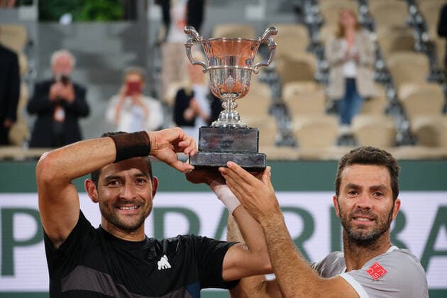 (220605) -- PARIS, June 5, 2022 -- Marcelo Arevalo (L) of Salvador and Jean-julien Rojer of the Netherlands pose with the trophy during the awarding ceremony after the men s doubles final match between Ivan Dodig of Croatia Austin Krajicek of the United States and Marcelo Arevalo of Salvador Jean-julien Rojer of the Netherlands at the French Open tennis tournament at Roland Garros in Paris, France, June 4, 2021. ) (SP)FRANCE-PARIS-TENNIS-ROLAND GARROS-FRENCH OPEN-MEN S DOUBLES-FINAL MengxDingbo 