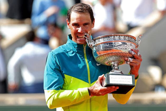 5th June 2022; Roland Garros, Paris, France: French Open Tennis tournament, mens singles final, Rafael Nadal versus Casper Ruud; Rafa Nadal (ESP) bites the winner& x2019;s trophy after his win against Casper Ruud (NOR)  ActionPlus12397498 JonxBromley