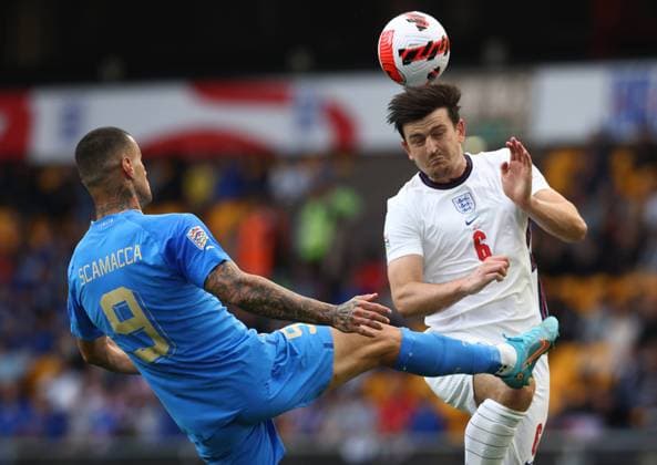 Wolverhampton, England, 11th June 2022. Harry Maguire of England clears under pressure from Gianluca Scamacca of Italy during the UEFA Nations League match at Molineux, Wolverhampton. Picture credit should read: Darren Staples Sportimage EDITORIAL USE ONLY. No use with unauthorised audio, video, data, fixture lists, club league logos or live services. Online in-match use limited to 120 images, no video emulation. No use in betting, games or single club league player publications. SPI-1732-0049