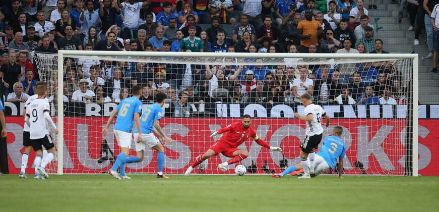 14 06 2022, football international match UEFA Nations League 2022 23, Germany Italy, at Borussia Park Mönchengladbach Josua Kimmich 2 v r, Germany goal shot to 1 0 against goalkeeper Gianluigi Donnarumma center, Italy , Leonardo Spinazzola r, Italy on the ground without a chance