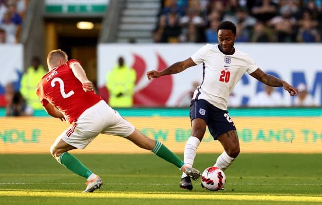 Wolverhampton, England, 14th June 2022. Adam Lang of Hungary tackles Raheem Sterling of England during the UEFA Nations League match at Molineux, Wolverhampton. Picture credit should read: Darren Staples Sportimage EDITORIAL USE ONLY. No use with unauthorised audio, video, data, fixture lists, club league logos or live services. Online in-match use limited to 120 images, no video emulation. No use in betting, games or single club league player publications. SPI-1734-0049