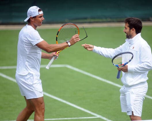 Tennis - 2022 All England Championships - Pre-evemnt practice - Wimbledon - Saturday 25th June 2022 Rafa Nadal borrows has coaches Sunglasses because of the sun 
