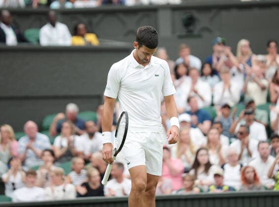 Serbian Novak Djokovic reacts in his match against Korean Soonwoo Kwon in the first round of the 2022 Wimbledon championships in London on June 27, 2022.  LON2022062703 HUGOxPHILPOTT