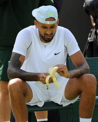Tennis - 2022 Wimbledon Championships - Week One - Day Two (Tuesday) - All England Lawn Tennis Club, Wimbledon - Tuesday 28th June 2022 Nick Kyrgios v Paul Jubb Nick Kyrgios of Australia eats his banana during the chance of ends 