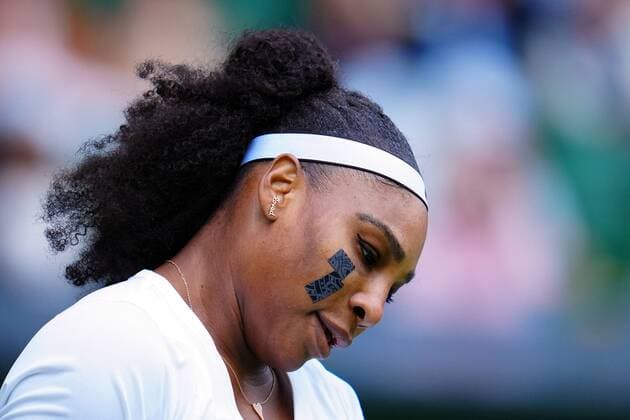 Mandatory Credit: Photo by Javier Garcia Shutterstock (13002021ka) Serena Williams sporting a plaster on her cheek and an earring that reads Loved during her first round match Wimbledon Tennis Championships, Day 2, The All England Lawn Tennis and Croquet Club, London, UK - 28 Jun 2022 Wimbledon Tennis Championships, Day 2, The All England Lawn Tennis and Croquet Club, London, UK - 28 Jun 2022  Copyright: xJavierxGarcia Shutterstockx 13002021ka