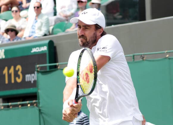 American Steve Johnson in action against Great Britain s Ryan Peniston on day three of the 2022 Wimbledon championships in London on Wednesday, June 29, 2022.  LON2022062904 HUGOxPHILPOTT