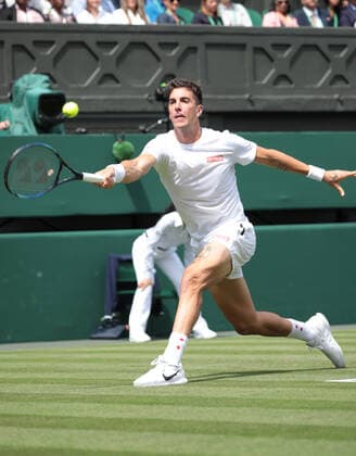 Australian Thanasi Kokkinakis in action against Serbian Novak Djokovic on day three of the 2022 Wimbledon championships in London on Wednesday, June 29, 2022.  LON2022062928 HUGOxPHILPOTT