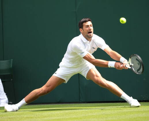 Serbian Novak Djokovic in action against Australian Thanasi Kokkinakis on day three of the 2022 Wimbledon championships in London on Wednesday, June 29, 2022.  LON2022062931 HUGOxPHILPOTT