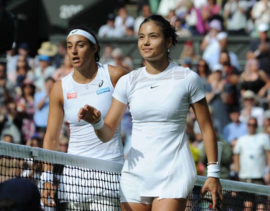Tennis - 2022 Wimbledon Championships - Week One - Day Two (Wednesday) - All England Lawn Tennis Club, Wimbledon - Wednesday 29th June 2022 Caroline Garcia v Emma Raducanu Emma Raducanu of Great Britain at the net after losing to Caroline Garcia 