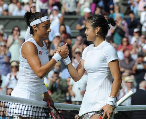 Tennis - 2022 Wimbledon Championships - Week One - Day Two (Wednesday) - All England Lawn Tennis Club, Wimbledon - Wednesday 29th June 2022 Caroline Garcia v Emma Raducanu Emma Raducanu of Great Britain at the net after losing to Caroline Garcia 
