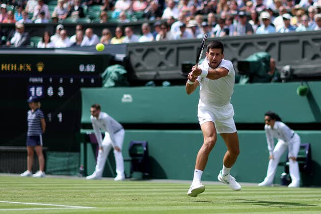 29th June 2022, All England Lawn Tennis and Croquet Club, London, England; Wimbledon Tennis tournament; Novak Djokovic plays a backhand return to Thanasi Kokkinakis in the mens singles  ActionPlus12402868 ShaunxBrooks