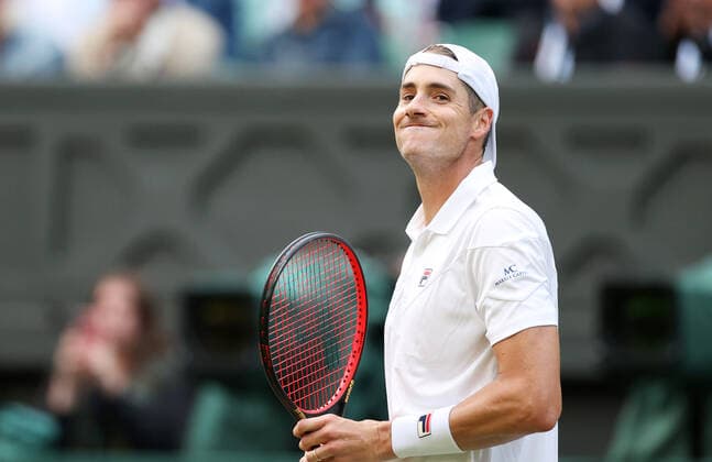 (220630) -- LONDON, June 30, 2022 -- John Isner of the United States reacts during the men s singles 2nd round match against Andy Murray of Britain at Wimbledon Tennis Championship in London, Britain, June 29, 2022. ) (SP)BRITAIN-LONDON-TENNIS-WIMBLEDON LixYing 