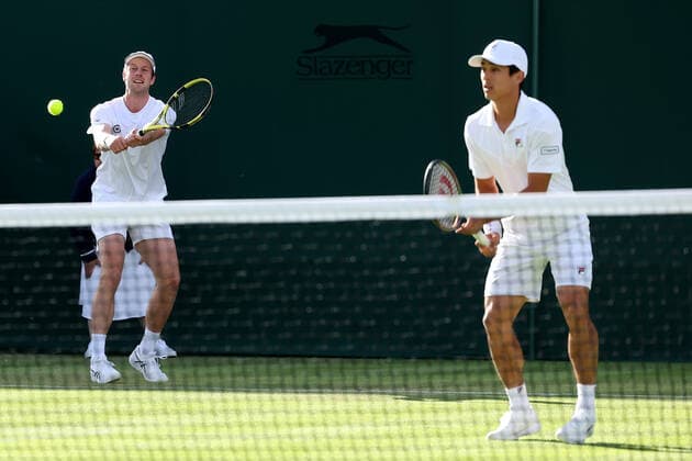 30th June 2022, All England Lawn Tennis and Croquet Club, London, England; Wimbledon Tennis tournament; Botic Van De Zandschulp plays a backhand to John Peers and Filip Polasek during his mens doubles match  ActionPlus12403111 ShaunxBrooks