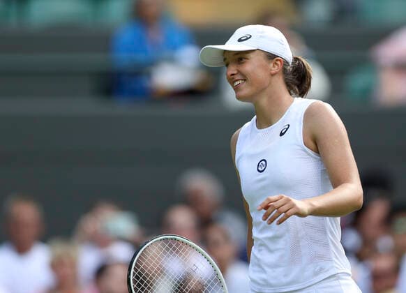 (220701) -- LONDON, July 1, 2022 -- Iga Swiatek reacts during the women s singles second round match between Iga Swiatek of Poland and Lesley Pattinama Kerkhove of the Netherlands at Wimbledon Tennis Championship in London, Britain, on June 30, 2022. ) (SP)BRITAIN-LONDON-TENNIS-WIMBLEDON-WOMEN S SINGLES HanxYan 