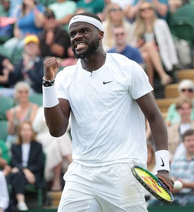 American Frances Tiafoe celebrates victory in his third round match against Kazakhstan s Alexander Bublik on day five of the 2022 Wimbledon championships in London on Friday, July 01, 2022. Tiafoe won the match 3-6,7-6,7-6,6-4.  LON2022070120 HUGOxPHILPOTT