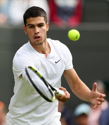 (220702) -- LONDON, July 2, 2022 -- Carlos Alcaraz hits a return during the men s singles third round match between Carlos Alcaraz of Spain and Oscar Otte of Germany at Wimbledon Tennis Championship in London, Britain, on July 1, 2022. ) (SP)BRITAIN-LONDON-TENNIS-WIMBLEDON-MEN S SINGLES HanxYan 