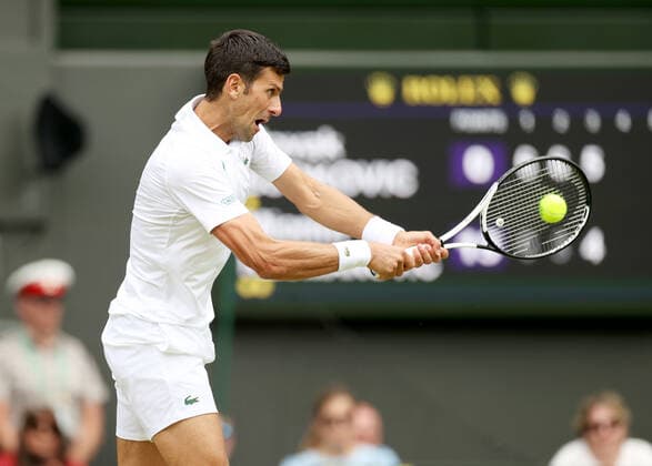 (220702) -- LONDON, July 2, 2022 -- Novak Djokovic hits a return during the men s singles third round match between Novak Djokovic of Serbia and Miomir Kecmanovic of Serbia at Wimbledon Tennis Championship in London, Britain, on July 1, 2022. ) (SP)BRITAIN-LONDON-TENNIS-WIMBLEDON-MEN S SINGLES LixYing 