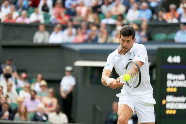 (220702) -- LONDON, July 2, 2022 -- Novak Djokovic hits a return during the men s singles third round match between Novak Djokovic of Serbia and Miomir Kecmanovic of Serbia at Wimbledon Tennis Championship in London, Britain, on July 1, 2022. ) (SP)BRITAIN-LONDON-TENNIS-WIMBLEDON-MEN S SINGLES LixYing 