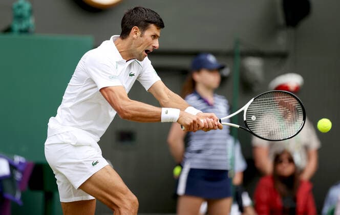 (220702) -- LONDON, July 2, 2022 -- Novak Djokovic hits a return during the men s singles third round match between Novak Djokovic of Serbia and Miomir Kecmanovic of Serbia at Wimbledon Tennis Championship in London, Britain, on July 1, 2022. ) (SP)BRITAIN-LONDON-TENNIS-WIMBLEDON-MEN S SINGLES LixYing 