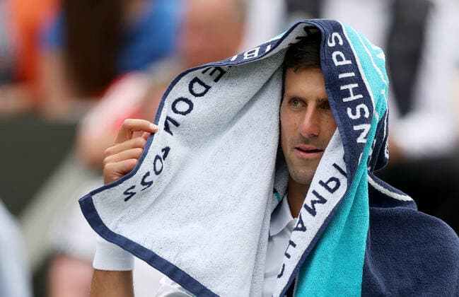 (220702) -- LONDON, July 2, 2022 -- Novak Djokovic reacts during the men s singles third round match between Novak Djokovic of Serbia and Miomir Kecmanovic of Serbia at Wimbledon Tennis Championship in London, Britain, on July 1, 2022. ) (SP)BRITAIN-LONDON-TENNIS-WIMBLEDON-MEN S SINGLES LixYing 