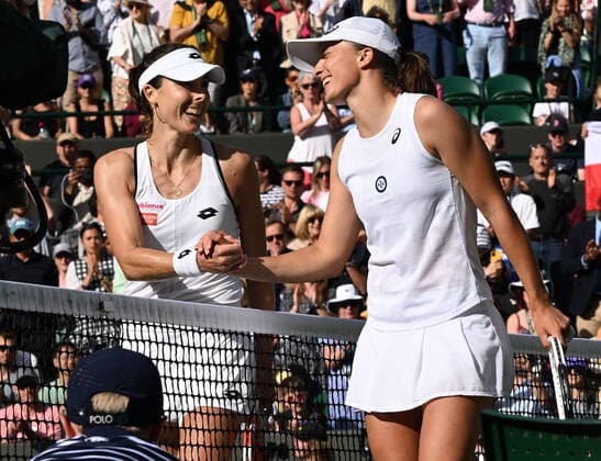 Tennis Championships - Week One - Day Six (Saturday) - All England Lawn Tennis Club, Wimbledon - Saturday 2nd July 2022 Iga Swiatek (POL) v Alize Cornet (FRA) Alize Cornet of France with Iga Swiatek after the match at the net 