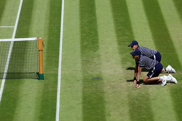 3rd July 2022, All England Lawn Tennis and Croquet Club, London, England; Wimbledon Tennis tournament; Wimbledon ball boys kneels ready at the net  ActionPlus12404417 ShaunxBrooks