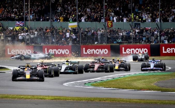 NORTHAMPTON Max Verstappen 1 with the Oracle Red Bull Racing RB18 Honda in the lead as Guanyu Zhou 24 crashes with the Alfa Romeo C40 in the background during the start of the F1 Grand Prix of Great Britain at Silverstone on July 3, 2022 in Northampton, England REMKO DE WAAL F1 Grand Prix of Great Britain 2022 xVIxANPxSportx xxANPxIVx 451278671 originalFilename: 451278671.jpg