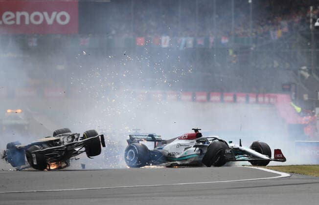 3rd July 2022, Silverstone Circuit, Silverstone, Northamptonshire, England: British F1 Grand Prix, Race day: Zhou Guanyu of China driving the (24) Alfa Romeo F1 C42 Ferrari is hit at the start and his car begins to roll down the track hitting George Russell of Great Britain driving the (63) Mercedes AMG Petronas F1 Team W13  ActionPlus12404614 SimonxWest