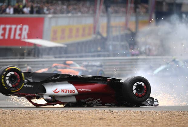 3rd July 2022, Silverstone Circuit, Silverstone, Northamptonshire, England: British F1 Grand Prix, Race day: Zhou Guanyu of China driving the (24) Alfa Romeo F1 C42 Ferrari is hit at the start and his car rolls, sliding upside down towards the barriers and gravel  ActionPlus12404624 SimonxWest