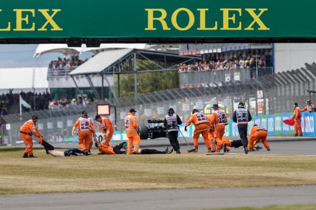 3rd July 2022, Silverstone Circuit, Silverstone, Northamptonshire, England: British F1 Grand Prix, Race day: Protestors are removed after running onto the track on the opening lap  ActionPlus12404703 TimxWilliams
