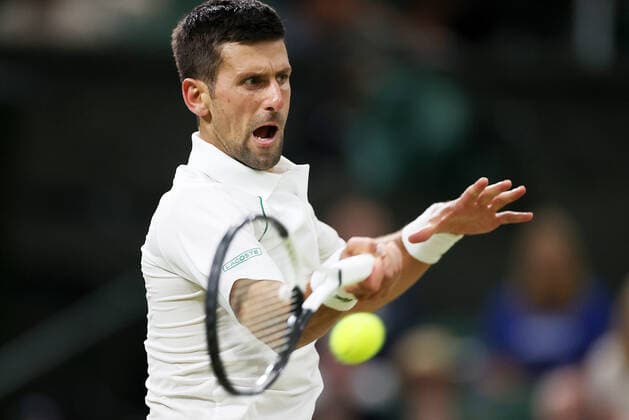 (220704) -- LONDON, July 4, 2022 -- Novak Djokovic of Serbia hits a return during the men s singles fourth round match against Tim Van Rijthoven of the Netherland at Wimbledon tennis Championship in London, Britain, on July 3, 2022. ) (SP)BRITAIN-LONDON-TENNIS-WIMBLEDON-MEN S SINGLES LixYing 
